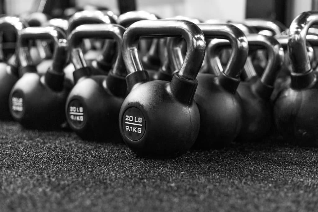 Tucson Strength Kettlebell Workouts. Set of kettlebells aligned for functional training.
