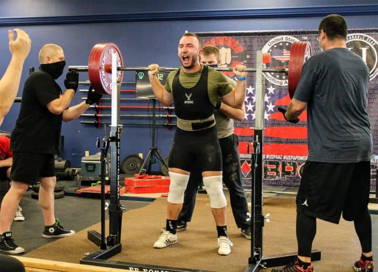 Tucson Strength Barbell Club Powerlifting Classes. A male client doing barbell back squat strength training.