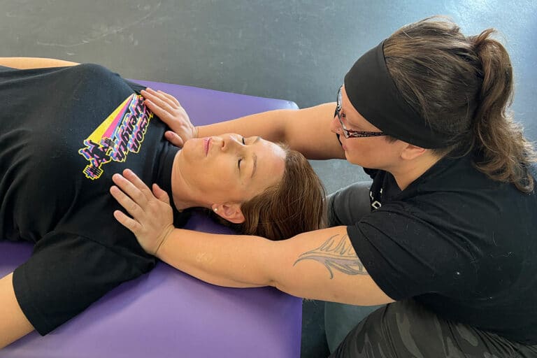 Fascial Stretch Therapy at Tucson Strength Gym. Image of Fascial Stretch Therapist Jessica VanAsselberg working with a client during a Fascial Stretch Therapy Session