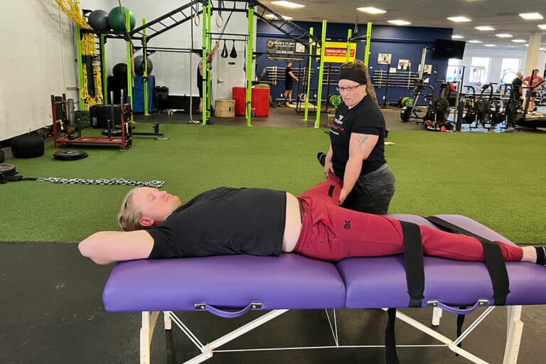 Tucson Strength Fascial Stretch Therapist. Jessica VanAsselberg-certified FST Therapist assisting a client during a Fascial Stretch Therapy session