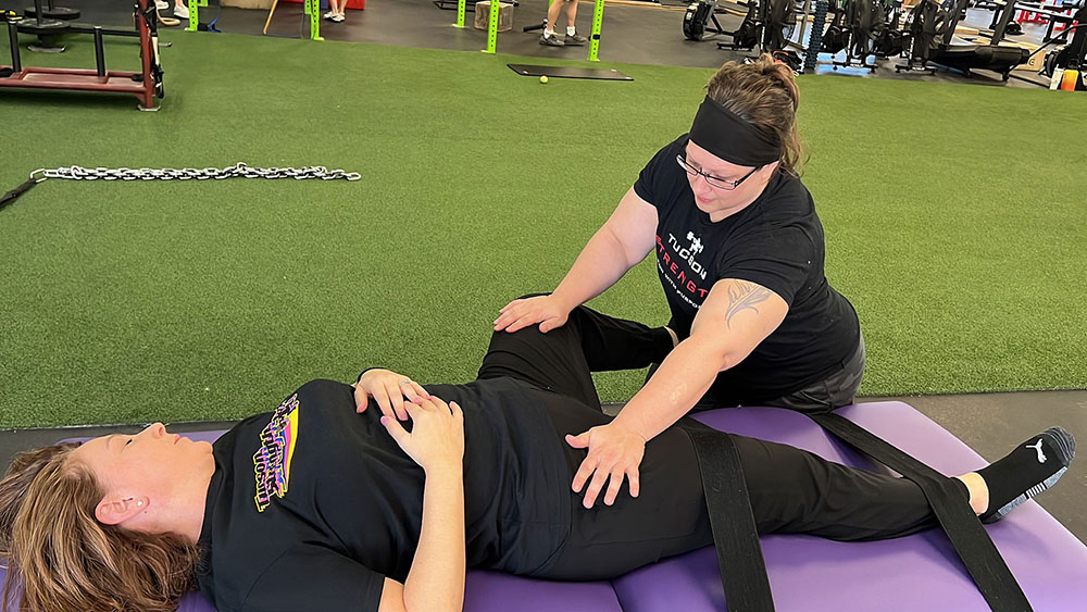 Tucson Strength Fascial Stretch Therapy. Certified FST Therapist Jessica VanAsselberg conducting a Fascial Stretch Therapy session with a client to improve flexibility.