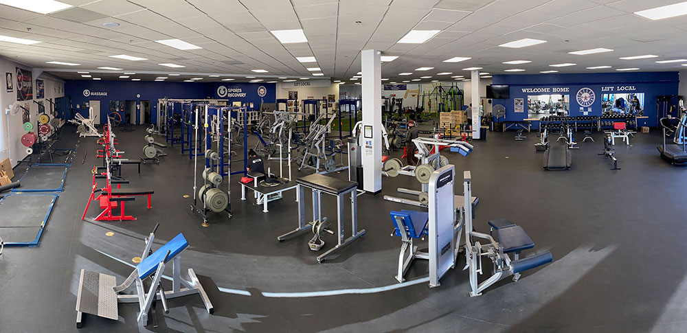 Tucson Strength Open Gym Area. Well-equipped open gym floor with exercise stations and equipment perfect for strength training and fitness.