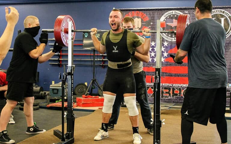 Tucson Strength Services - Barbell Club Powerlifting Team. Athlete performs squat at powerlifting competition.